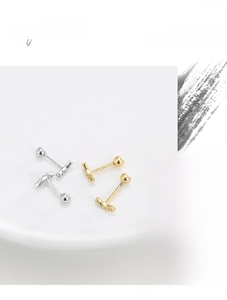 Detailed shot of curved micro-inset zircon stud earrings in silver and gold plating