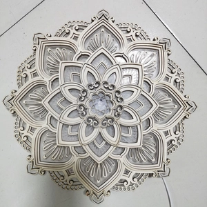Detail of multi-layered wooden mandala wall art with soft LED lighting effects
