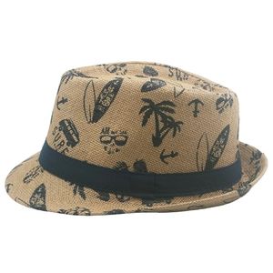 Detail of straw fedora sun hat with surf print and navy blue decorative band