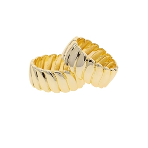 Detailed close-up of two golden croissant rings with textured ribbed design on white background