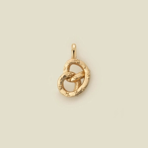 Detailed view of a gold-plated twisted pretzel charm with textured surface and simple ring