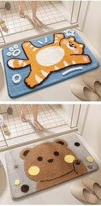 Detail of high-density tufted bathroom mats with cartoon tiger and bear designs