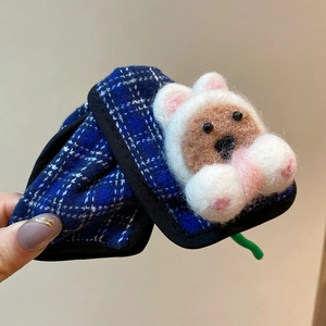Detailed close-up of blue plaid claw clip with 3D wool felt bear doll hair accessory
