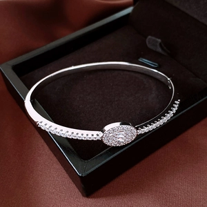 Detail view of 18K silver plated oval clasp bracelet featuring micro-pave zirconia stones