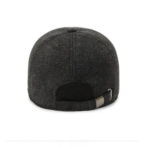 Detail view of the back of a winter baseball cap featuring textured wool and metal buckle