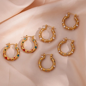 Detailed close-up of 18K gold plated hoop earrings with pearls and colorful zircons