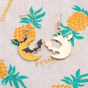 Detailed view of moon and bat enamel earrings with gold plating for Halloween fashion