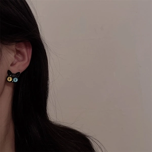 Cat head earrings with black finish and unique blue and yellow eyes for women