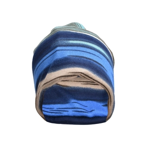 Detail view of the colorful striped knit pattern and soft texture on the slouchy beanie hat