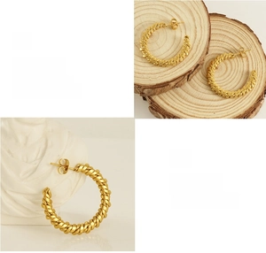 Detailed macro view of 18K gold plated hoop earrings with vintage twisted rope texture