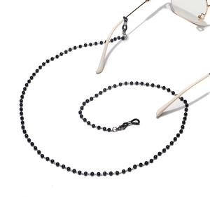 Elegant black beaded eyewear chain with adjustable rubber loops on white background