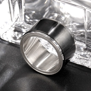 Close-up of 8mm men's spinner ring with black brushed exterior and silver inner band