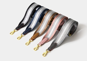 Detail of five striped woven replacement straps with gold hardware in various colors
