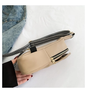 Dettaglio borsa beige in PU con tracolla a onde e chiusure lampo dorate di alta qualità