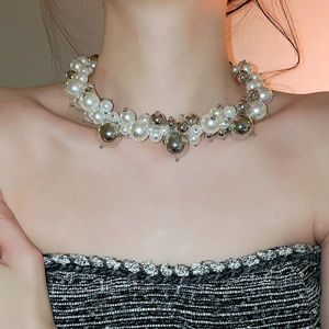 Detail of French vintage necklace with irregular pearls and polished silver metal beads