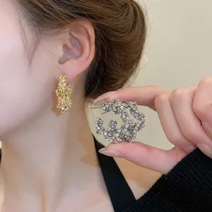 Sparkling star-shaped hoop earrings with micro-pave crystals in gold and silver finish
