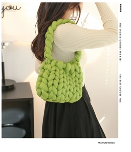 Close-up of bright green chunky knit handbag showing thick cotton rope texture and weave