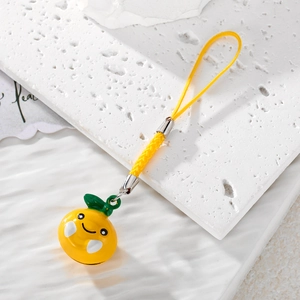 Cute 3D yellow fruit phone charm with smiley face and green leaf decoration on cord