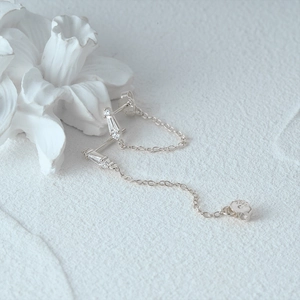 Detailed close-up of S925 sterling silver chain earrings with sparkling cubic zirconia