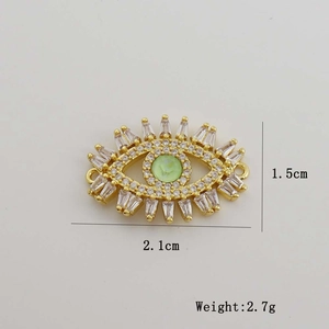 Macro view of 18K gold-plated evil eye pendant with dimensions and weight specs