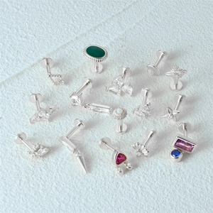 Macro shot of assorted S925 sterling silver opal and diamond stud earrings on white background