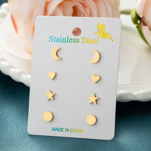 Set of four gold stainless steel stud earrings featuring moon, heart, star and round shapes