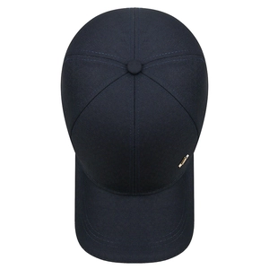 Navy blue baseball cap made of twill fabric with a gold metal plaque from a top-down view