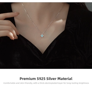 Detailed view of S925 silver starburst necklace with blue topaz on a velvet background