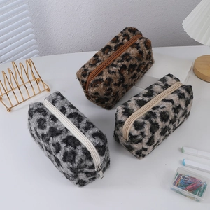 Three plush leopard print makeup bags in brown, grey, and beige with soft winter texture