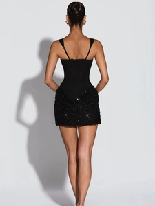 Back view of a sleek black bodycon dress with sequin hem and adjustable spaghetti straps