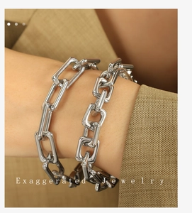 Detailed close-up of a silver chunky chain bracelet with bold metallic finish on a wrist