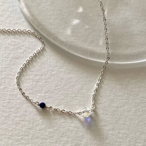 Elegant 925 sterling silver necklace with navy blue bead and faceted iridescent crystal
