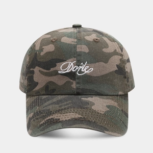 Macro detail of custom Doris embroidery on a vintage washed camouflage baseball cap