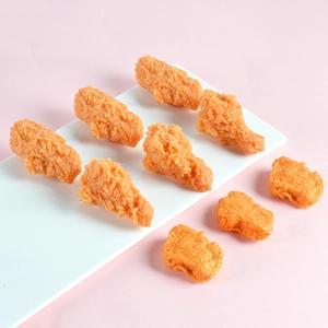 Detailed macro view of realistic PVC fried chicken wings and nuggets food model props
