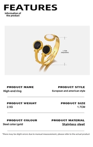 Detail view of gold stainless steel open ring with black and white circular enamel inlays
