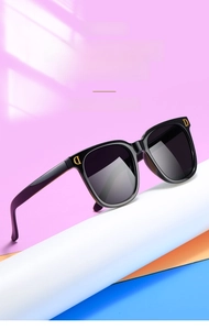 Détail de lunettes de soleil carrées noires pour enfants avec logo D doré chic
