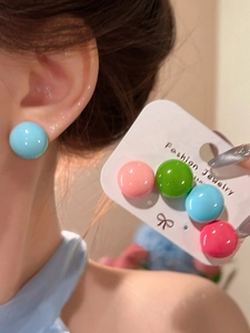Detailed close-up of colorful dopamine round stud earrings with vibrant glossy finish