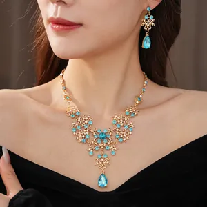 Vintage flower necklace and earrings set with sky blue zircon drops on gold base