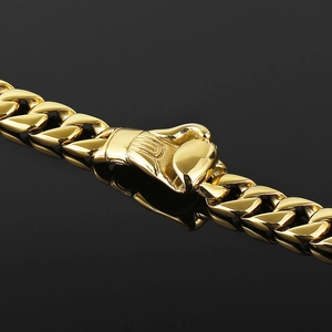 Macro shot of gold Cuban chain link bracelet featuring a detailed boxing glove pendant clasp