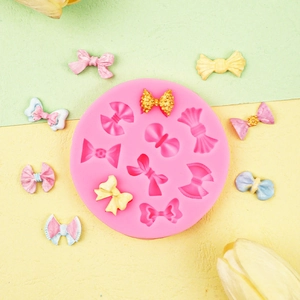Pink silicone mold featuring 10 assorted bow designs for fondant cake and chocolate DIY