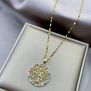 Golden Tree of Life necklace with colorful zircon stones on a silk satin background