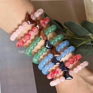 Detail of beaded butterfly bracelets set with sparkly stones in various pastel colors