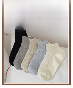 Detailed view of 5 pairs of breathable mesh socks with ruffled cuffs and ribbon bows