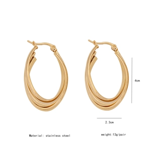 Detailed view of 4cm gold-colored triple-layered twisted stainless steel C-shape earrings