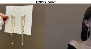 Close-up of long tassel star earrings with sparkling cubic zirconia on a model