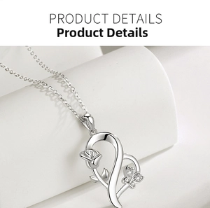Macro detail of S925 silver heart necklace with rose branch and diamond butterfly