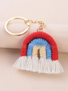 Macro view of handmade knit rainbow keychain with colorful cotton rope and white fringe
