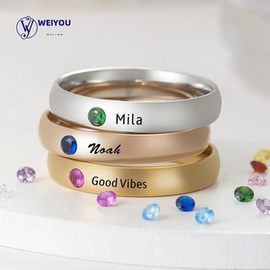 Detailed macro view of three personalized rings in gold, silver and rose gold with engraving