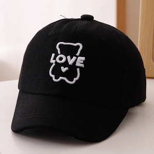 Close-up of black cotton baseball cap with white LOVE bear embroidery and heart detail