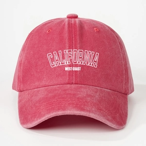 Close-up of red washed cotton baseball cap featuring California West Coast white print